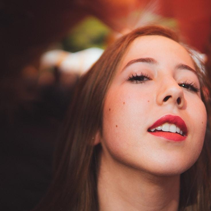 Arielle Moore, Lead Design Curator at Glimmering Peak Network, reviewing corporate floral arrangements